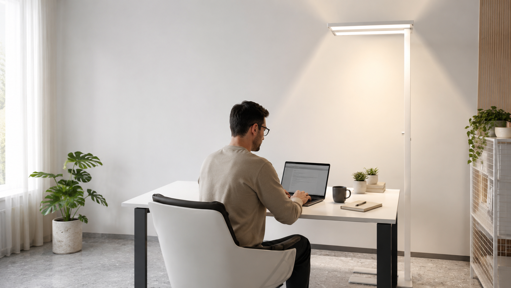 Remote worker using a tall LED floor lamp in a bright home office